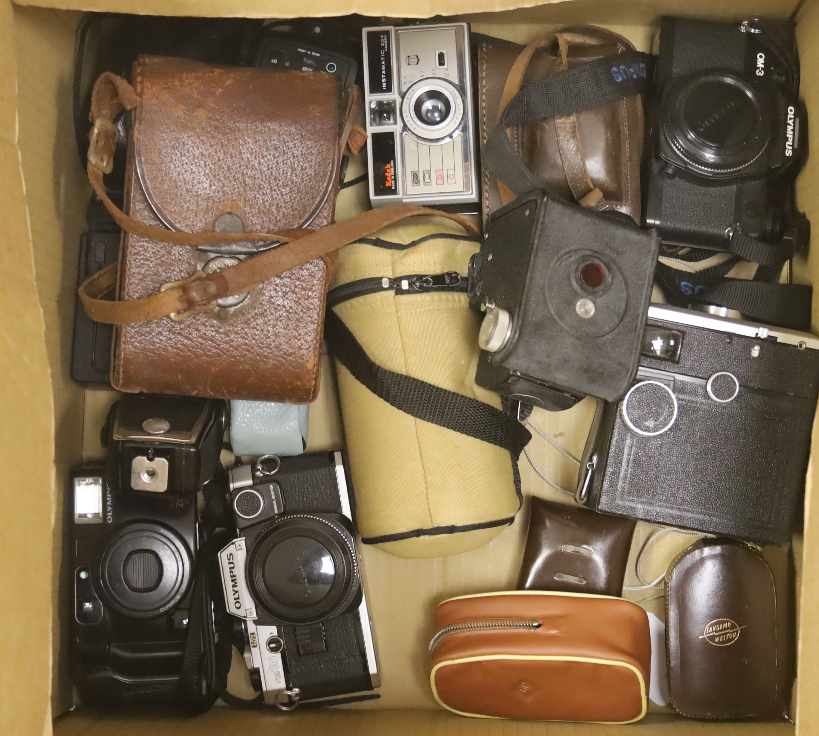 A quantity of cameras and lenses including Olympus